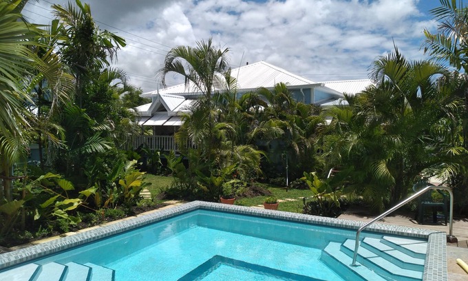 Hastings Apartment | Crotona Garden 2 Bed Apt, Lush and Tropical with Pool. 2 Minutes Walk to Sea