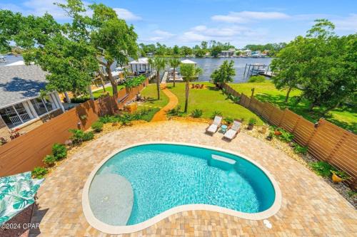 Holiday Beach House | Dancin on the Waves On Lagoon Boat dock, Pool, Firepit