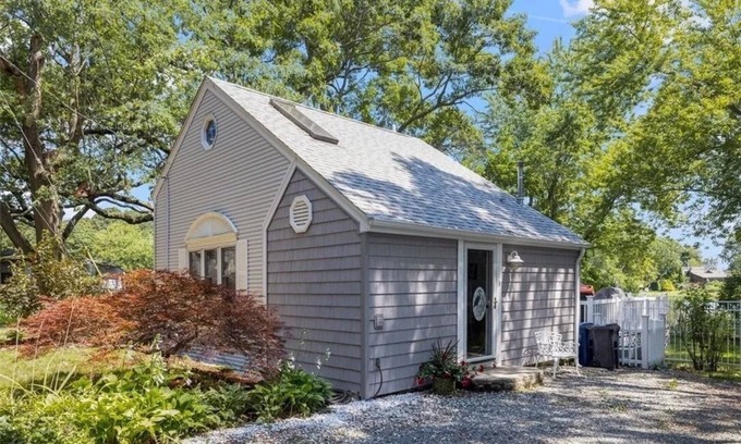Warwick House | Freshly renovated waterfront retreat in Warwick Cove! This cozy 1-bedroom features a loft-style king bed, queen sleeper sofa, spacious deck, fenced yard, and open backyard leading to the water - perfect for a relaxing coastal escape.
