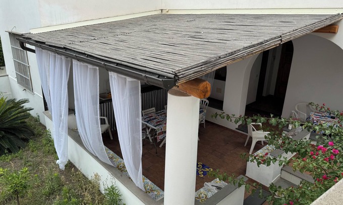 Stromboli Villa | Green room with 4 beds, bathroom and patio with equipped kitchen