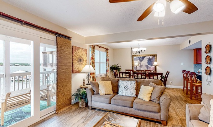Gulf Shores Condo | Lagoon-front condo with balcony, washer/dryer, shared pool, & dock