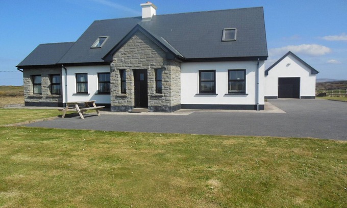 Quilty House | Luxurious family home with spectacular views close to shops, pub and beaches