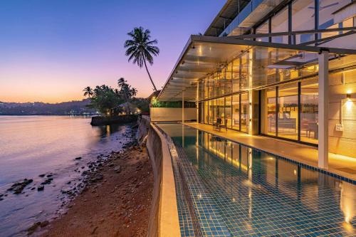 Verem Villa | Oceanic Sunsets with River View, Comp Breakfast & Infinity Pool at StayVista