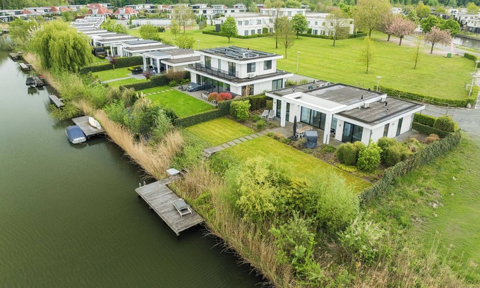 Zeewolde House | Private Finnish sauna, Luxury kitchen with bean coffee maker and large gas stove, With swimming jetty on the water.