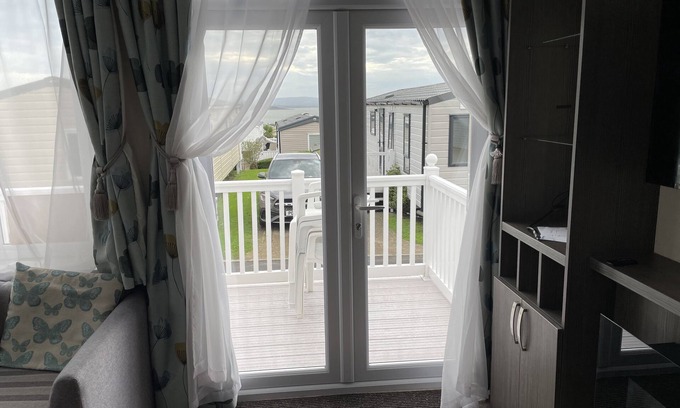 Hamworthy House | Rambling Rose caravan with sea view on Rockley Park