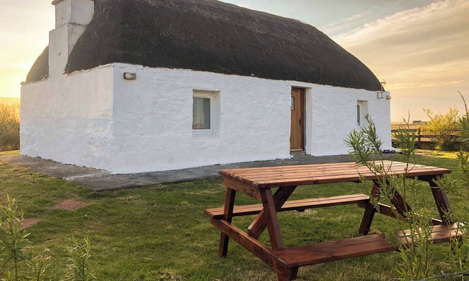 Benbecula Cottage | The cottage is so attractive with its traditional thatch and whitewashed walls.
