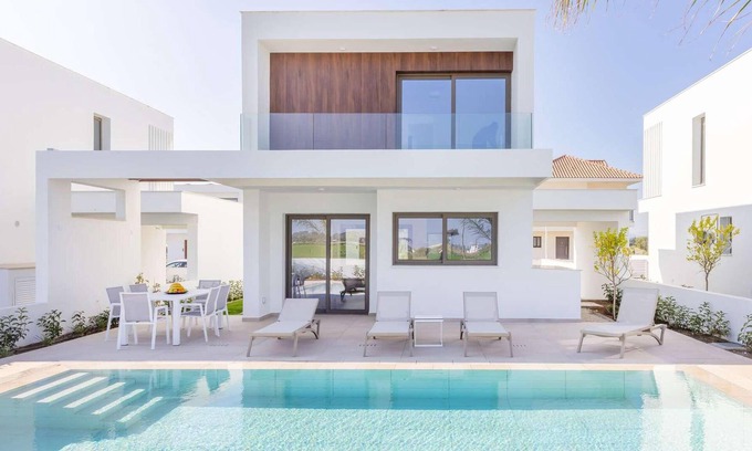 Softades House | This modern villa in a gated complex has pretty landscaped gardens and is within walking distance of