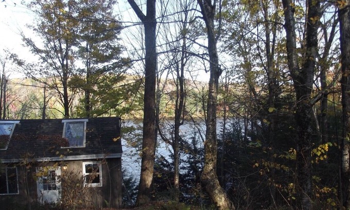 Grantham Cottage | Waterfront Camp looking down on water from deck.