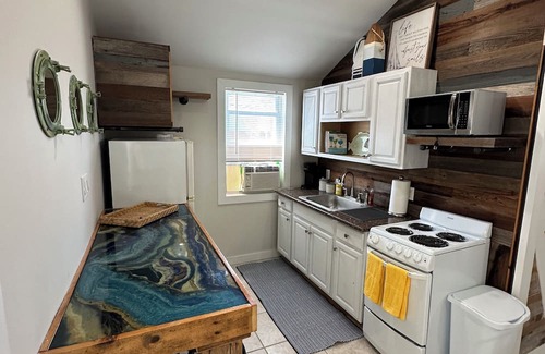 Patchogue Cottage | A charming yellow cottage , where you can place your feet in the sand and relax!