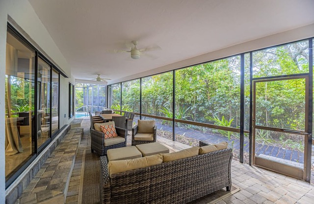 Gorgeous Naples home with open-concept layout, sunroom, enclosed pool, & AC